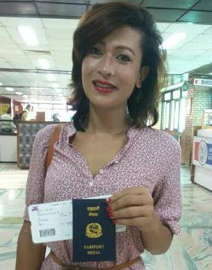 Bhumika Shrestha proudly holds up her passport as the first transgender person to fly using her new passport that denotes “other” as her gender, as she boards a plane to New Delhi, India on Tuesday, October 6. (Photo: Courtesy of the Blue Diamond Society)