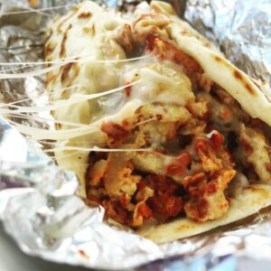 Sisters Reyna and Maritza Vasquez serve up a rockin' breakfast taco at Veracruz All Natural Food Truck in Austin, Texas. (Photo: Super G)