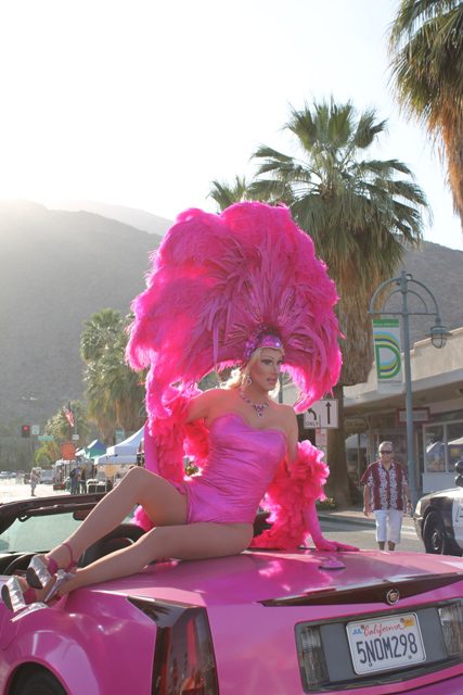 A drag queen models atop a car in downtown Palm Springs, California. (Photo: Super G)