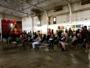 Visitors admire and think about the images of women sliding before them on the screens that form a circle at the “Women: New Portraits” exhibit at Crissy Field in the Presidio in San Francisco. (Photo: Heather Cassell)