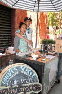 Rica Sunga-Kwan, left, owner and ice cream maker of Churn Urban Creamery, with her husband Christopher Kwan, right, helping her out at the cart. (Photo: Heather Cassell)