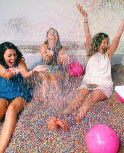 Girls get giddy in the Sprinkles Pool at the Museum of Ice Cream. (Photo: Pintrest)