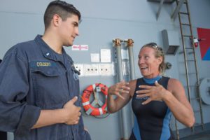 Jennifer Appel, from Honolulu, recalls her experience to Lt. j.g. Cody Colbert, the boat officer who aided in the rescue of her and another distressed mariner, aboard the amphibious dock landing ship USS Ashland. (Photo: US Navy)