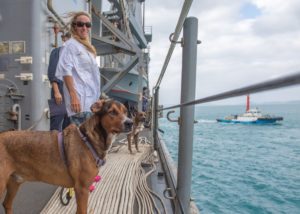 Jennifer Appel, a rescued sailor, pose with dogs Zeus and Valentine on board the USS Ashland. (Photo: US Navy)