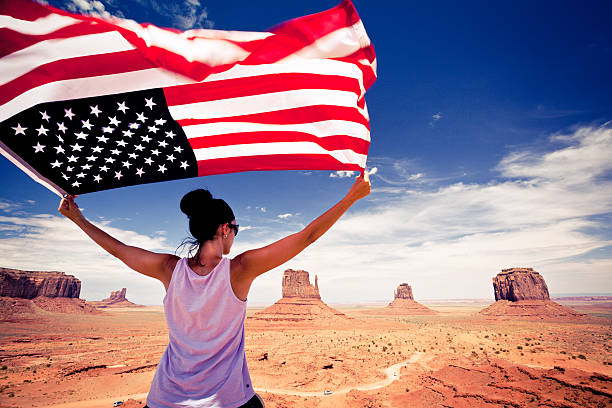 Woman with US Flag at Monument Valley, USA Landmark