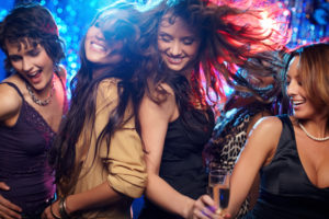 Young women having fun dancing at nightclub