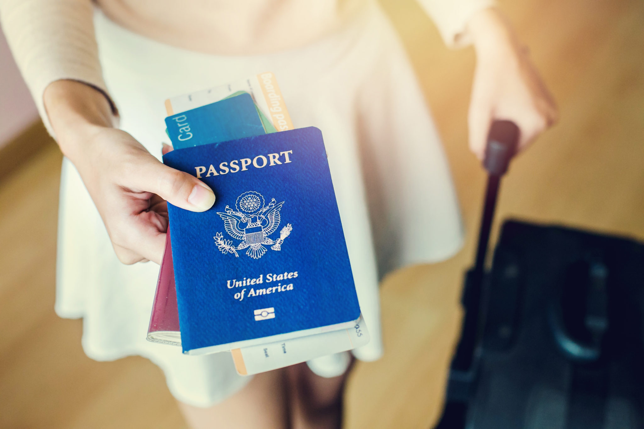 Closeup of girl holding passports and boarding pass