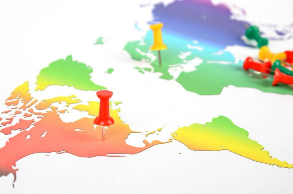 Rainbow-World-Map-Push-Pin-AdobeStock-Xuejun-li